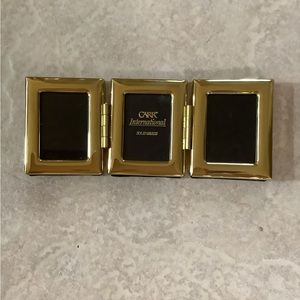 Brass photo frame. Size 1 1/4 by 1 3/4 inches. Excellent condition.
